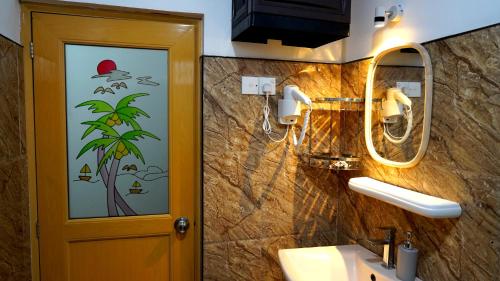 a bathroom with a sink and a mirror at Premier Villa Tangalle in Tangalle