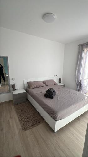 a bedroom with a bed with a backpack on it at SunshineSuite in Alassio