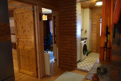a hallway of a house with a brick wall at Poropelto Cottage in Ruhtinaansalmi