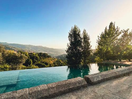 a swimming pool with a view of a mountain at Quinta de Travanca - Casa do Páteo, Baião, Douro in Baião