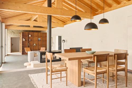 a kitchen and dining room with a wooden table and chairs at Quinta de Travanca - Casa do Páteo, Baião, Douro in Baião