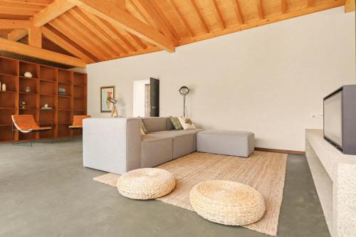 a living room with a couch and a tv at Quinta de Travanca - Casa do Páteo, Baião, Douro in Baião