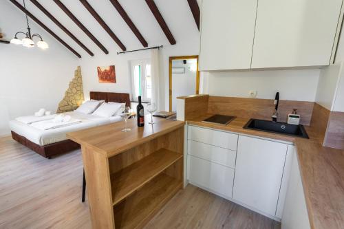 a room with a bed and a kitchen with a counter at Guesthouse Imperator in Split