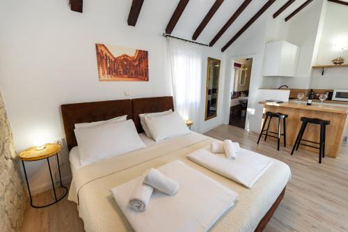 a bedroom with a large bed and a kitchen at Guesthouse Imperator in Split