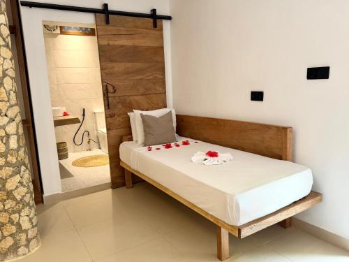 a bedroom with a bed with flowers on it at Stone Resort in Kiwengwa