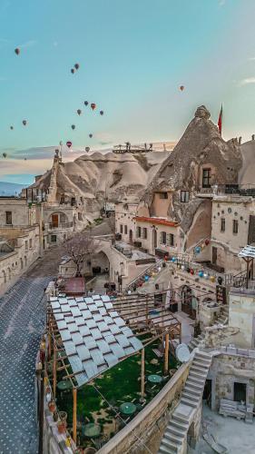 a group of kites flying in the sky over a city at Ascension Cave Suites - Special Class in Göreme