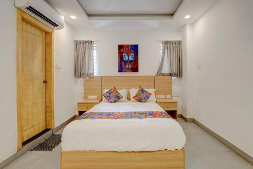 a bedroom with a large bed in a room at FabHotel NA Grand in Chennai