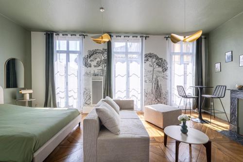 a bedroom with a bed and a living room at EMMA - Centre Historique - Parking privée - CLIM in Auch