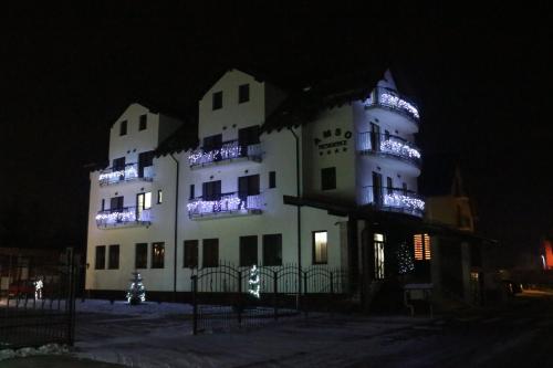 a large white building with lights on it at night at Amso Residence in Sibiu