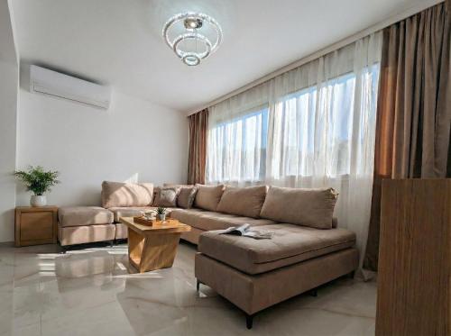 a living room with a couch and a large window at Elite Country House in Ialysos
