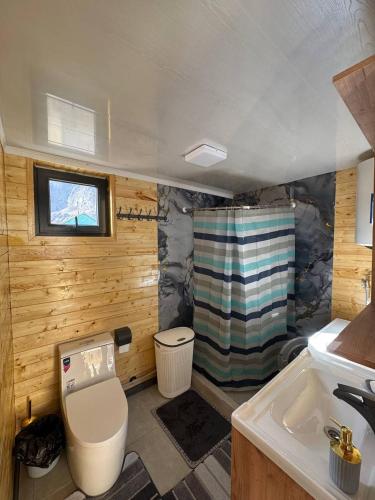 a small bathroom with a toilet and a sink at Khan Guest House in Engilʼchek