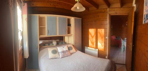 a bedroom with a bed in a small room at Le Chamois in Le Tartre