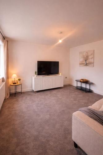 a living room with a large flat screen tv at Bright & Spacious 3-Bed Rotherham Home Ideal for Families or Contractors in Kimberworth