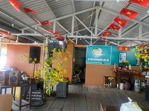 a room with flowers and a sign on the wall at Cần Giờ Floating House in Ấp Phước Thới