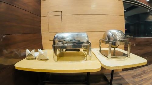 a table with two helmets on display in a store window at Hotel Sawood International in Kolkata