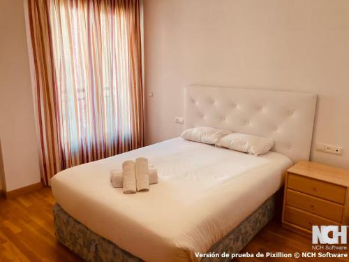 a bedroom with a bed with two towels on it at Duque de Ahumada 8 in Soria