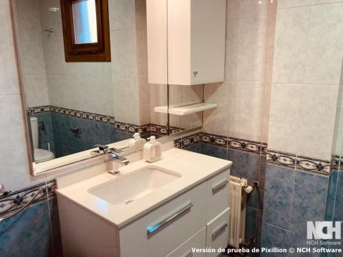 a bathroom with a white sink and a mirror at Duque de Ahumada 8 in Soria
