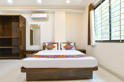 a bedroom with a large bed in a room at FabHotel Rama in Indore