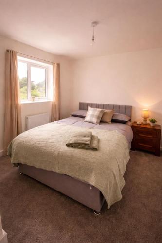 a bedroom with a large bed with a window at New Build 3-Bed in Rotherham Fast WiFi, Garden & Driveway in Kimberworth