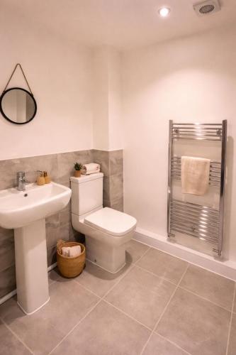 a bathroom with a toilet and a sink and a shower at New Build 3-Bed in Rotherham Fast WiFi, Garden & Driveway in Kimberworth