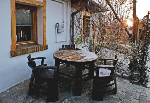 a table and chairs sitting next to a building at FOLK in Old Town in Kecskemét