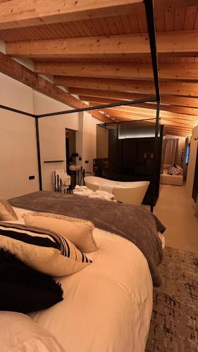 a bedroom with three beds and a wooden ceiling at Enoa Casa Cueva - Alojamiento rural in Requena