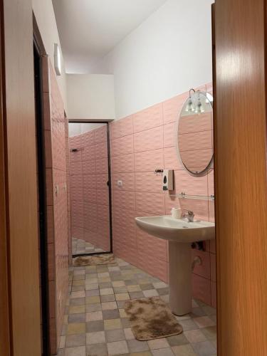 a bathroom with a sink and a shower with a mirror at Shiroke Relax Villa in Shirokë