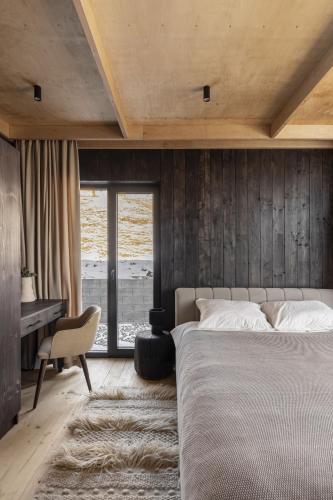 a bedroom with a large bed and a desk at Mountain air Horishnii in Palyanytsya
