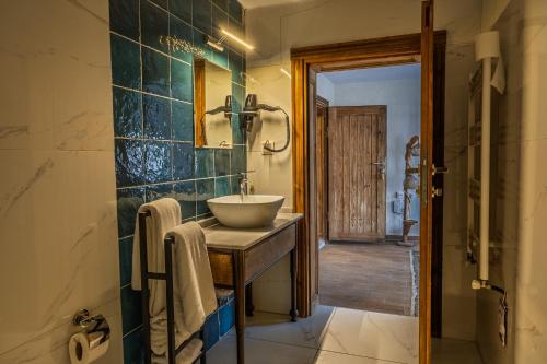 a bathroom with a sink and a mirror at Ayaz Stone House in Göreme