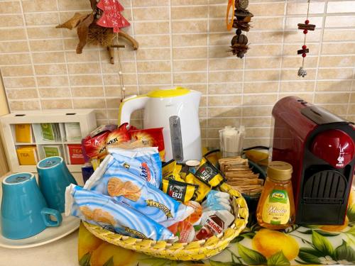 a counter top with a basket of food and a toaster at Casa Etna Soul in Paterno