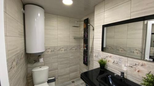 a bathroom with a sink and a toilet and a mirror at Modern Stay Provadia in Provadiya