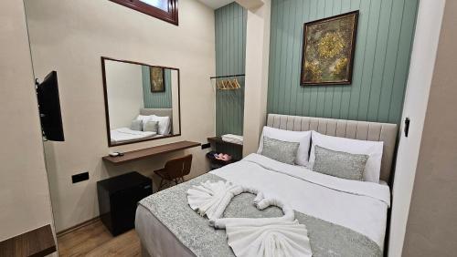 a bedroom with a bed and a mirror at Konak 83 in Nicosia