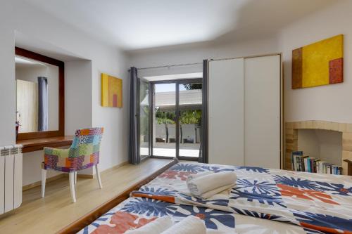 a bedroom with a bed and a chair and a window at Nice double bedroom in beautiful Quinta - QR06 in Lagos