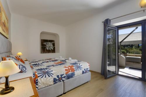 a bedroom with a bed and a sliding glass door at Great double bedroom in beautiful Quinta - QR07 in Lagos