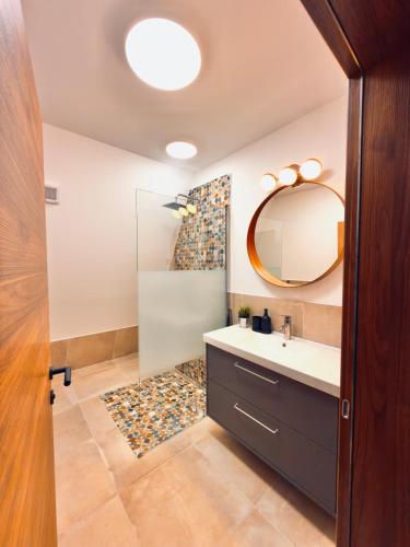 a bathroom with a sink and a mirror at Villa Perush in Vuzenica