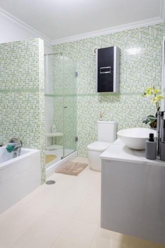 a bathroom with a toilet and a sink and a shower at The Spot - ilha de São Miguel (Povoação) Açores in Povoação