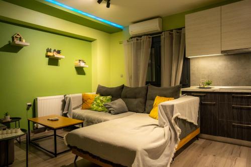 a living room with a couch and a kitchen at Tsitsipas Apartment in Alexandroupoli