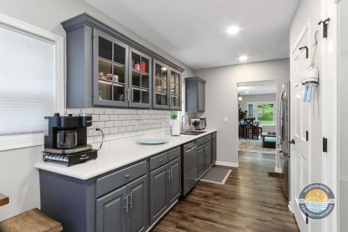 a kitchen with blue cabinets and a microwave at Charming Pet-Friendly Lake Retreat in Lake Geneva