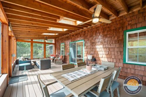 a screened in porch with a table and chairs at Lake Geneva Escape 4BR Arcade Fire Pit and Deck in Lake Geneva