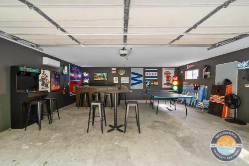 a room with two tables and stools in it at Lake Geneva Escape 4BR Arcade Fire Pit and Deck in Lake Geneva