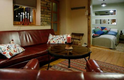 a living room with a couch and a table with a candle at FOLK in Old Town in Kecskemét