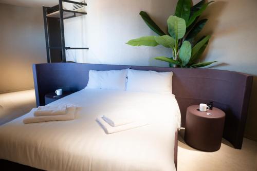 a bedroom with a bed with two towels on it at Ku Private Milano in Pero