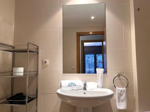 a bathroom with a sink and a mirror at AC Apartaments Saüc Canillo in Canillo