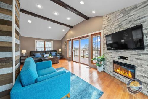 a living room with a blue couch and a fireplace at Exclusive Lake Como Escape with Bar and Pool Table in Lake Geneva