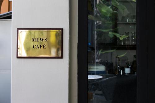 a sign on a door with the words means cafe at Muntri Mews in George Town