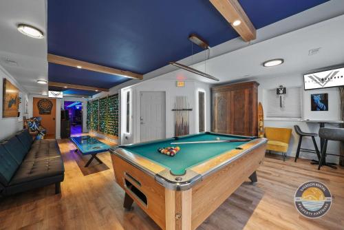 a room with a pool table and a couch at Event Lounge with Pool Table and Arcade in Lake Geneva
