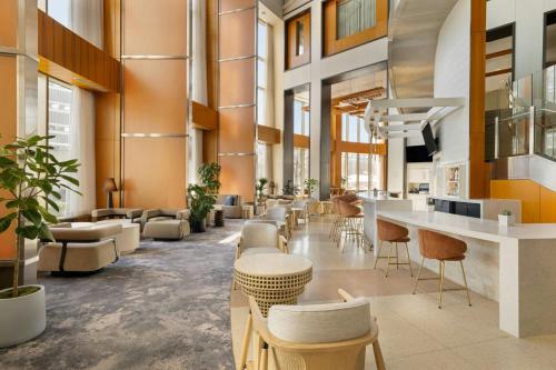 a lobby with chairs and tables in a building at The Westin Jersey City Newport in Jersey City