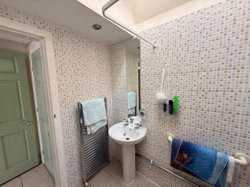 a bathroom with a sink and a mirror at Casa G in Bridlington