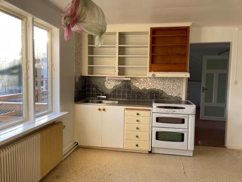 a kitchen with a white stove and a window at Gästis in Sollefteå