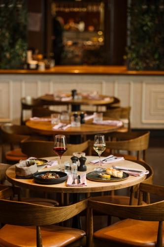 a group of tables with wine glasses and food at Budapest Marriott Hotel in Budapest
